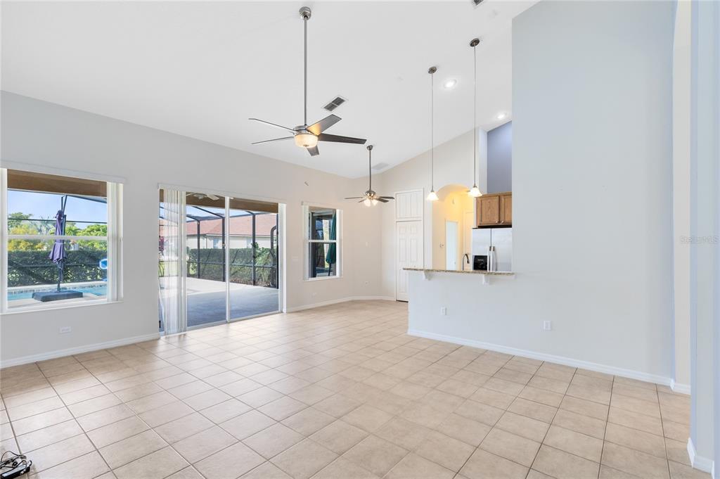 3510 Pawleys Loop South St. Cloud, FL 34769 - Photo 13 of 32 a view of a kitchen with furniture and floor to ceiling window