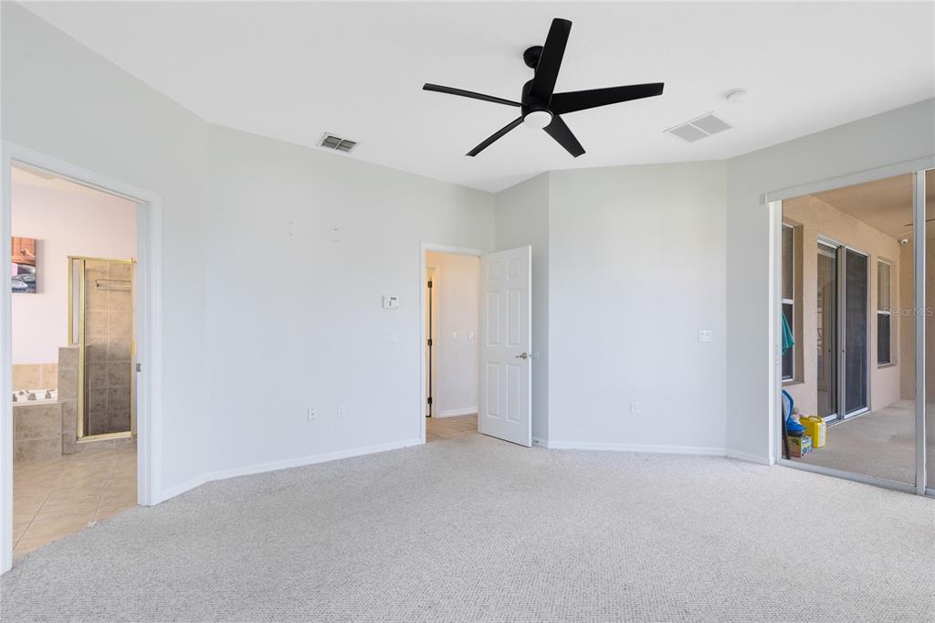 3510 Pawleys Loop South St. Cloud, FL 34769 - Photo 19 of 32 a view of a livingroom with a ceiling fan and entryway