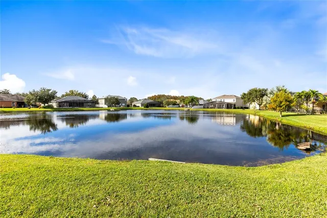 a view of a lake with houses in the back