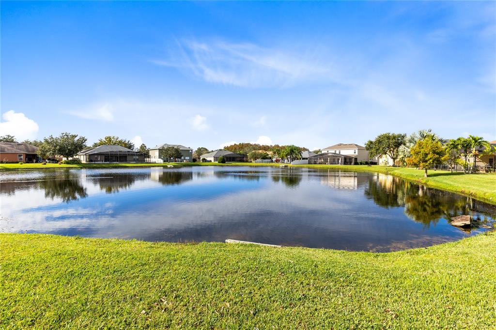 3510 Pawleys Loop South St. Cloud, FL 34769 - Photo 27 of 32 a view of a lake with houses in the back