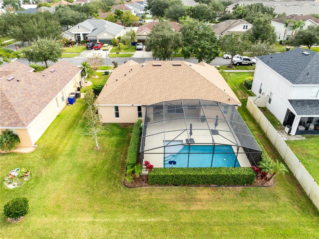 3510 Pawleys Loop South St. Cloud, FL 34769 - Photo 30 of 32 an aerial view of a house with swimming pool and large trees