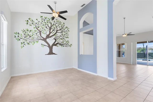 an empty room with a white walls and chandelier