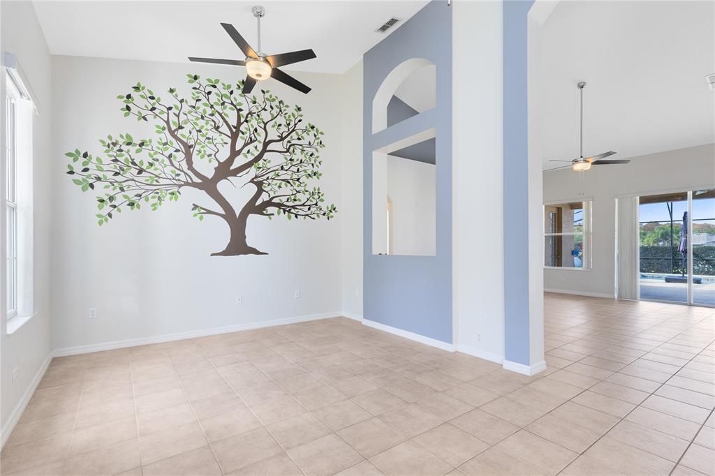 3510 Pawleys Loop South St. Cloud, FL 34769 - Photo 3 of 32 an empty room with a white walls and chandelier