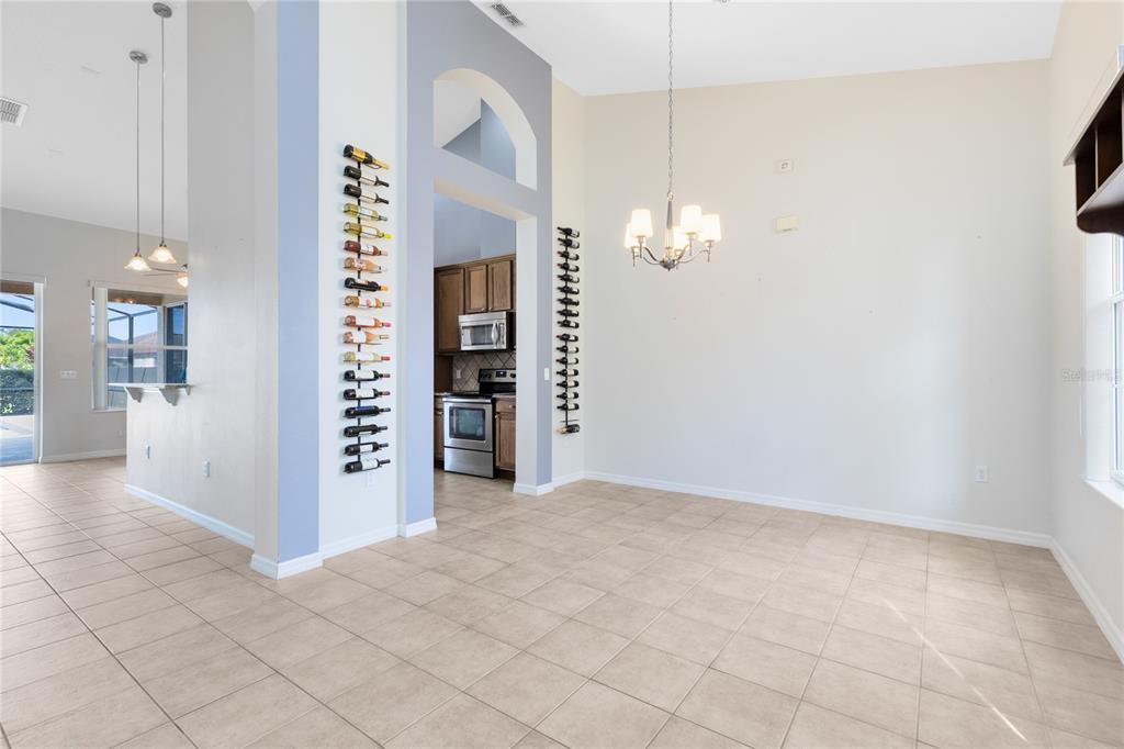3510 Pawleys Loop South St. Cloud, FL 34769 - Photo 4 of 32 an empty room with kitchen and windows