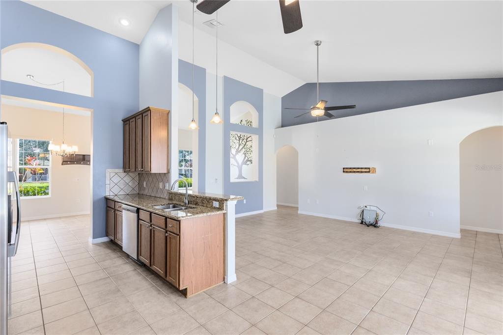 3510 Pawleys Loop South St. Cloud, FL 34769 - Photo 9 of 32 a kitchen with stainless steel appliances granite countertop a stove and a sink with granite countertops