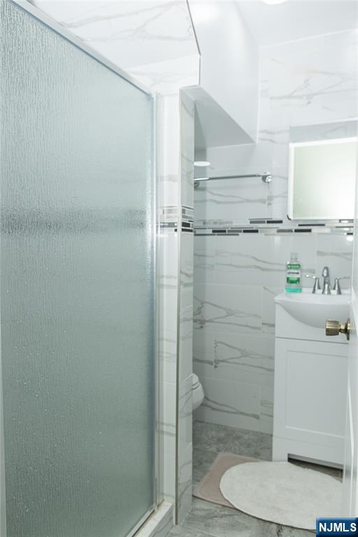 37 Riverside Avenue Little Ferry, NJ 07643 - Photo 19 of 34 a bathroom with a shower a toilet and sink