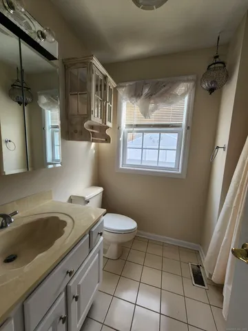 a bathroom with a sink a toilet and tub