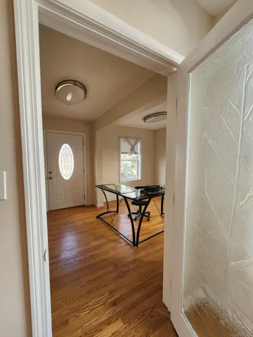 a view of a livingroom with wooden floor and a staircase