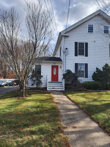 a view of a house with swimming pool next to a yard