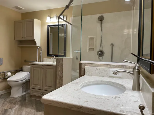 a bathroom with a sink toilet and shower