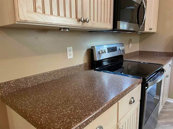 a kitchen with granite countertop a sink and a stove