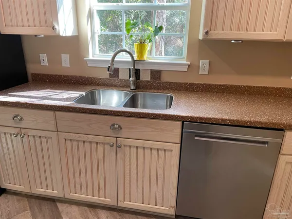 a kitchen with a sink cabinets and window