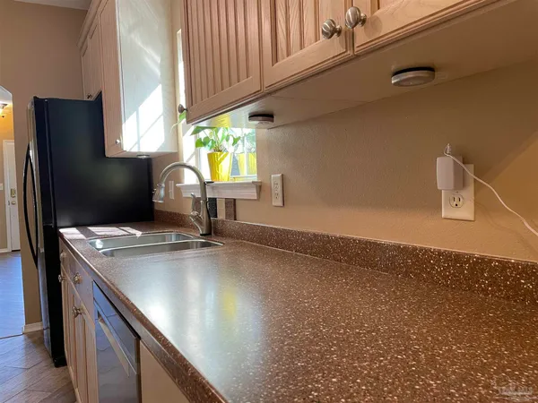a kitchen with kitchen island a sink appliances and cabinets
