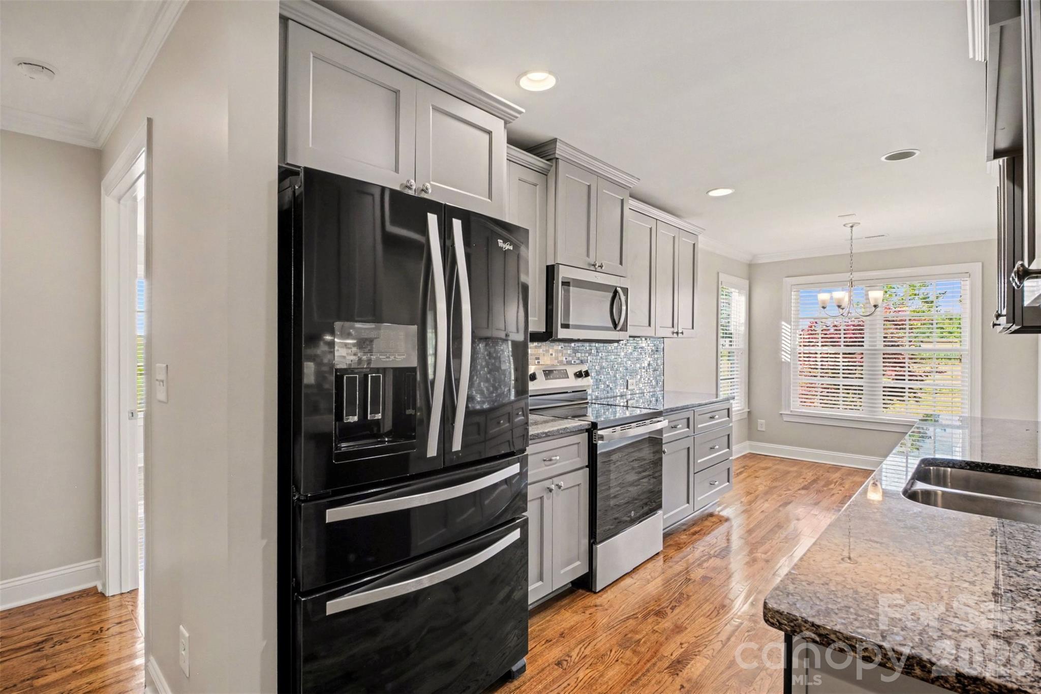 3604 Rilla Hamilton Road Monroe, NC 28110 - Photo 16 of 46 a kitchen with granite countertop stainless steel appliances and wooden cabinets