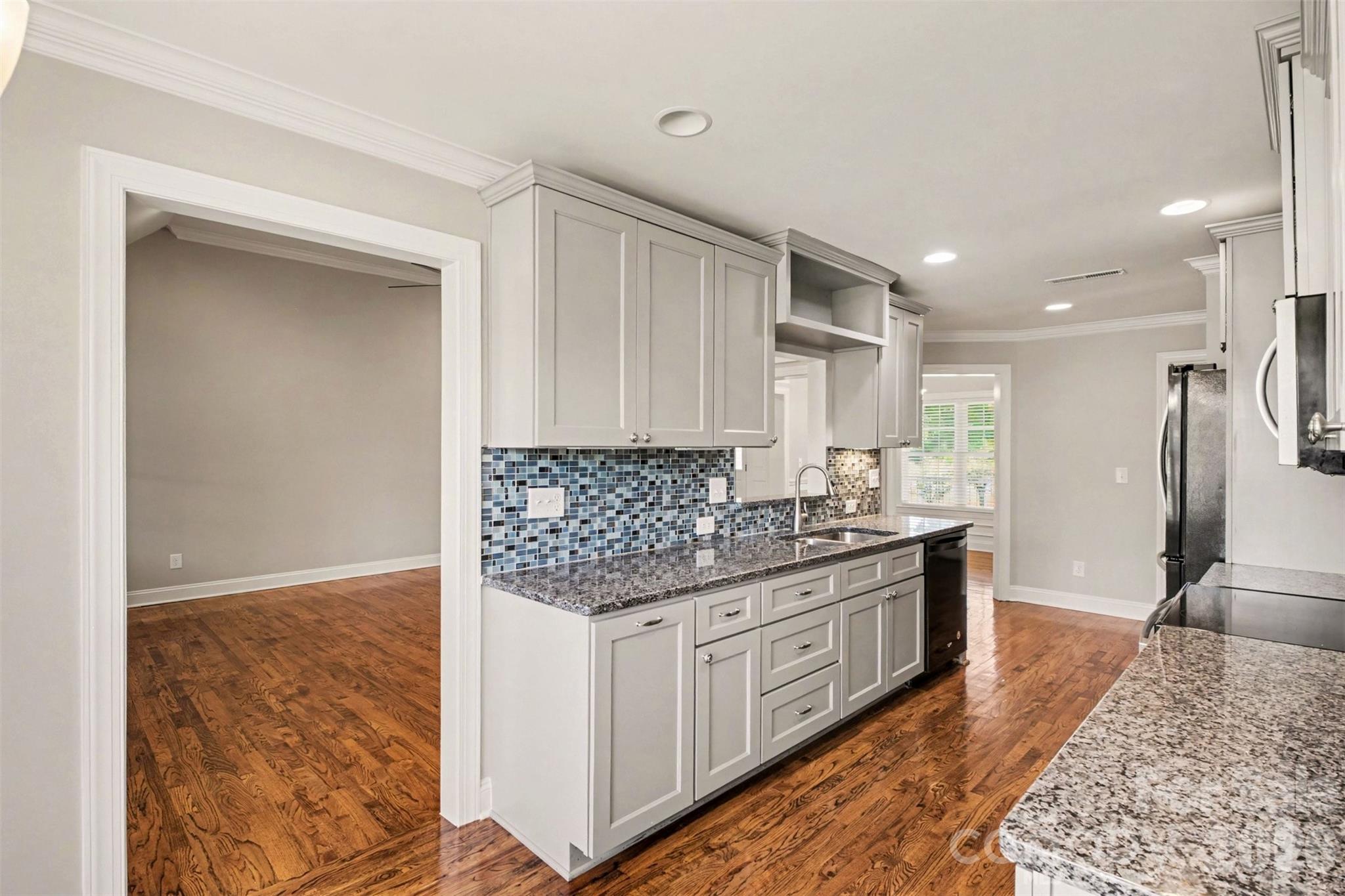 3604 Rilla Hamilton Road Monroe, NC 28110 - Photo 20 of 46 a kitchen with stainless steel appliances granite countertop a stove a sink and a refrigerator