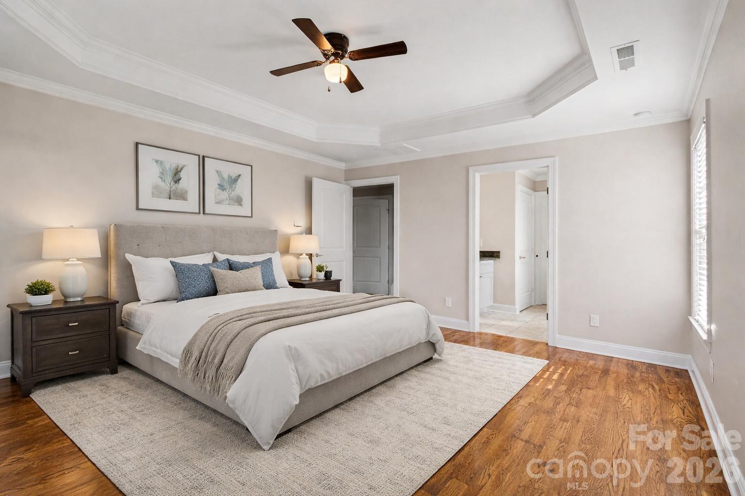 3604 Rilla Hamilton Road Monroe, NC 28110 - Photo 28 of 46 a spacious bedroom with a bed and a chandelier