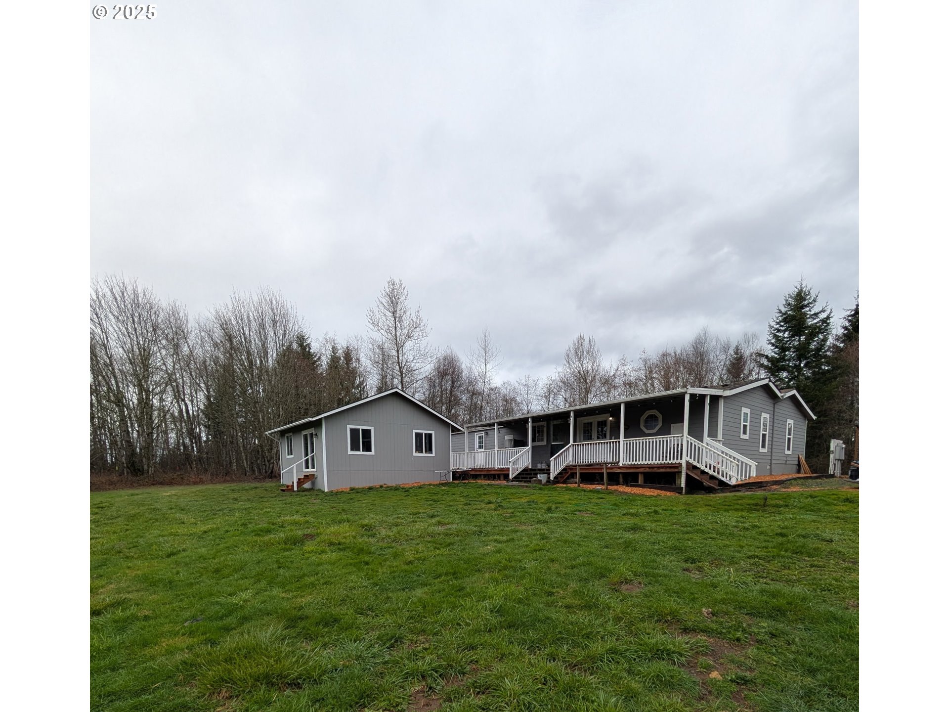 34241 Southeast Colorado Road Sandy, OR 97055 - Photo 2 of 37 a view of a house with a big yard and large trees