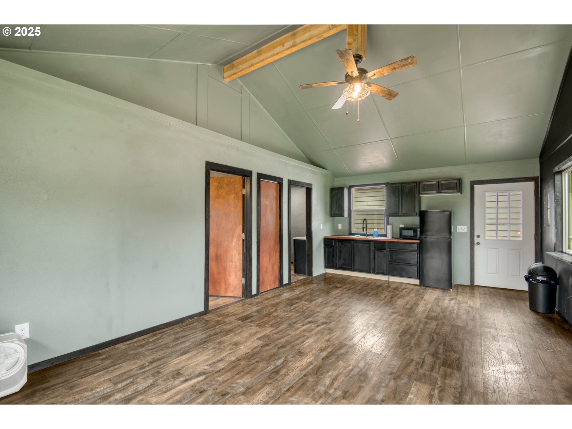 34241 Southeast Colorado Road Sandy, OR 97055 - Photo 21 of 37 a view of a livingroom with a ceiling fan and kitchen view