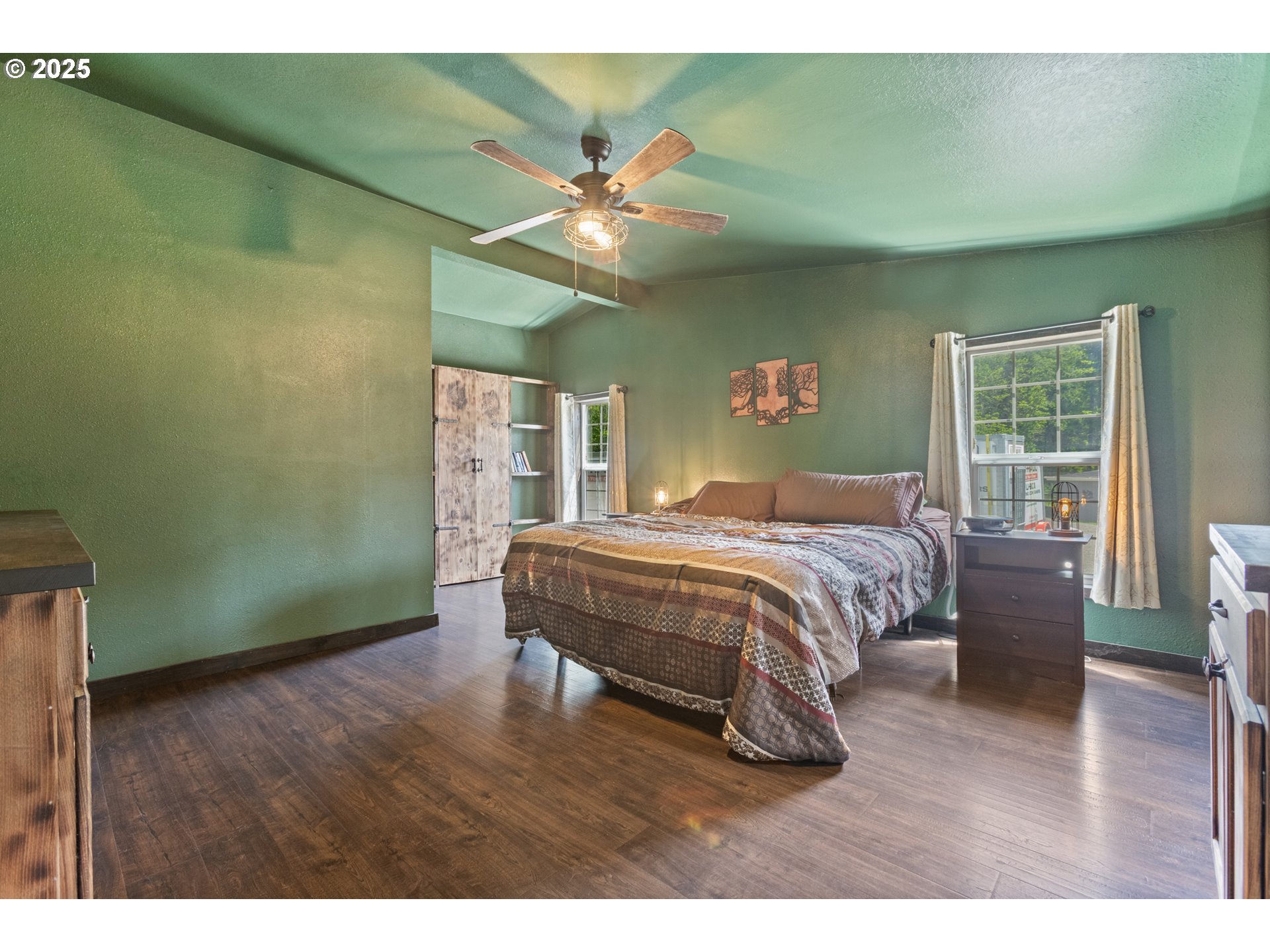 34241 Southeast Colorado Road Sandy, OR 97055 - Photo 36 of 37 a bedroom with a large bed and a chandelier