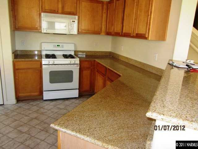 9050 Double R Boulevard, Unit 1224 Reno, NV 89521 - Photo 2 of 8 a kitchen with a sink cabinets and appliances