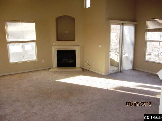9050 Double R Boulevard, Unit 1224 Reno, NV 89521 - Photo 5 of 8 an empty room with windows and fireplace