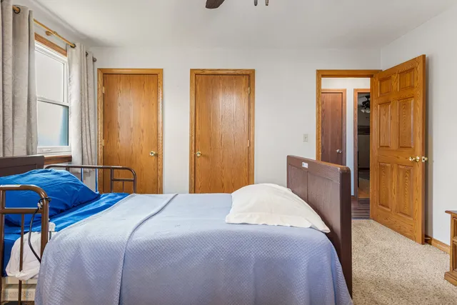 a bedroom with two beds and a window