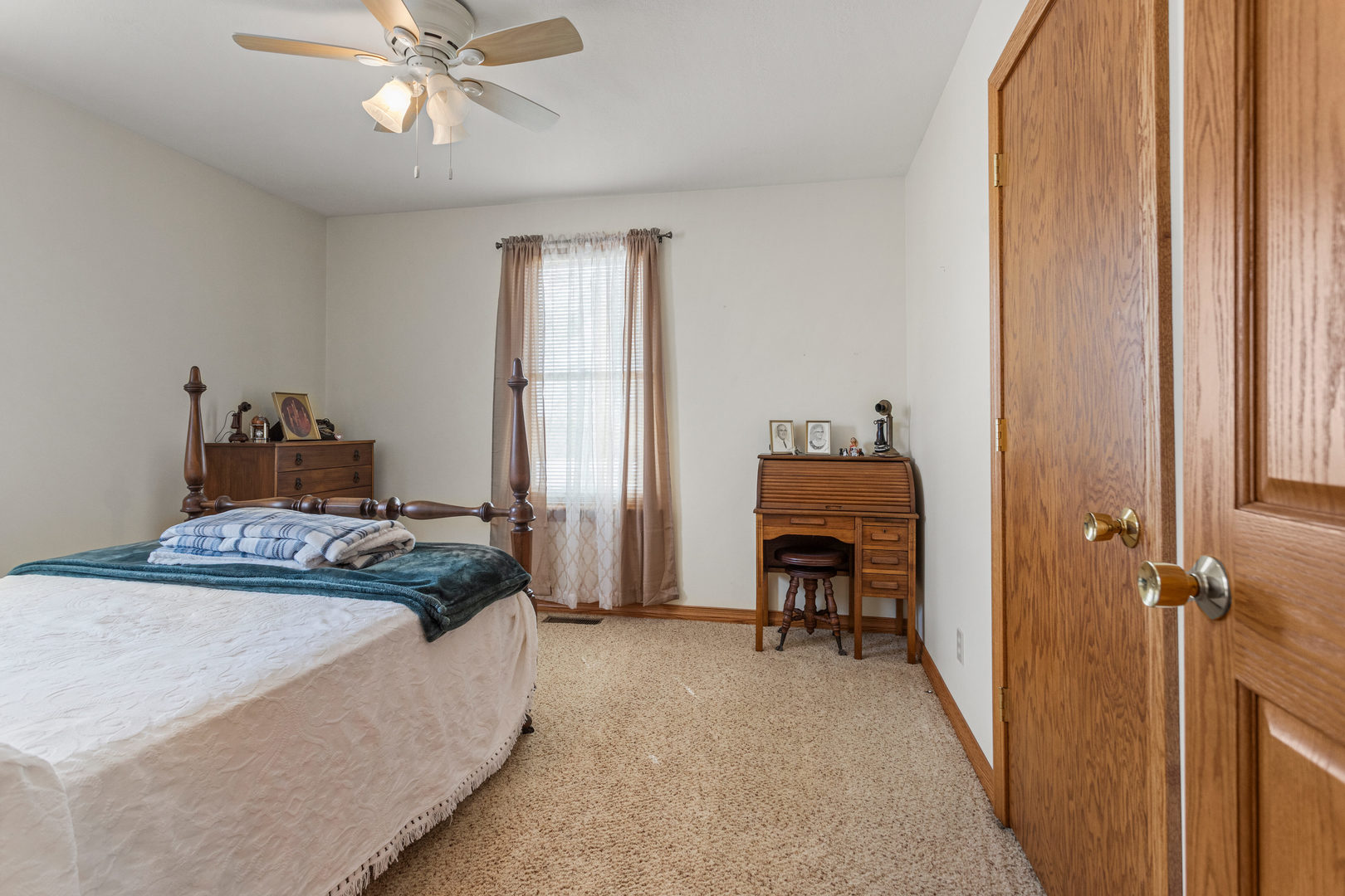 708 East Benham Street Tolono, IL 61880 - Photo 27 of 34 a bedroom with a bed and a chandelier