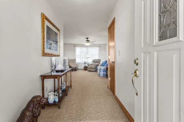 a view of a livingroom with furniture and a window