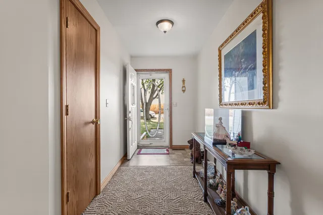 a view of a hallway with couches and a livingroom