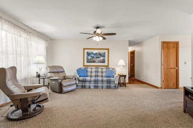 a living room with furniture gym equipment and a window