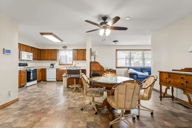 a living room with stainless steel appliances kitchen island granite countertop furniture and a kitchen view