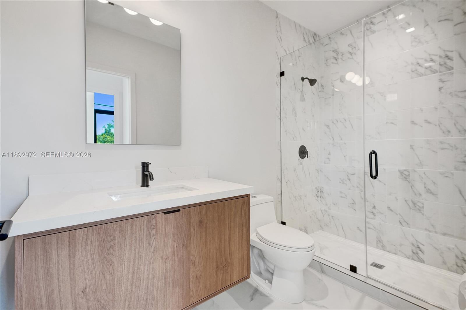 525 Northeast 61st Street Miami, FL 33137 - Photo 13 of 37 a bathroom with a sink a toilet and shower