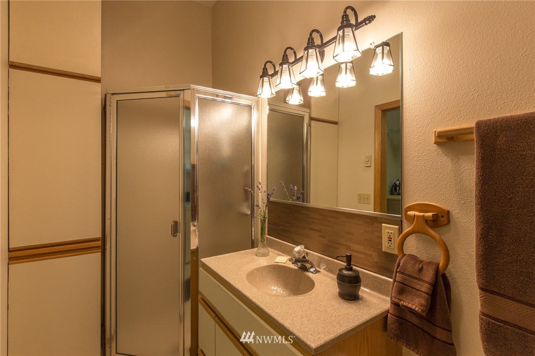 226 Guy Kelly Road Port Angeles, WA 98362 - Photo 28 of 40 a bathroom with a sink vanity and a mirror