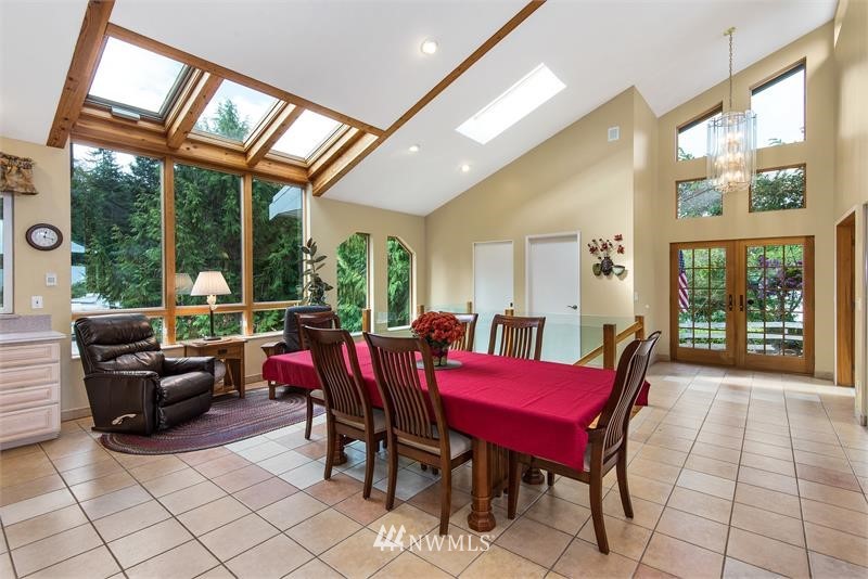 226 Guy Kelly Road Port Angeles, WA 98362 - Photo 4 of 40 a view of a dining room with furniture large windows and a livingroom