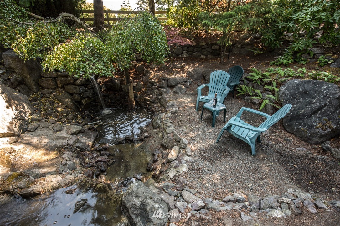 226 Guy Kelly Road Port Angeles, WA 98362 - Photo 31 of 40 a view of a backyard with chairs and a tree