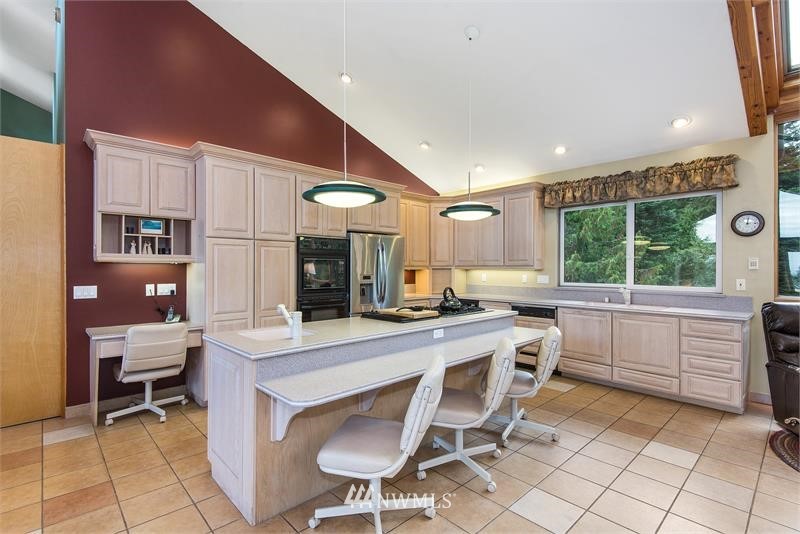 226 Guy Kelly Road Port Angeles, WA 98362 - Photo 5 of 40 a kitchen with a stove a table and chairs in it