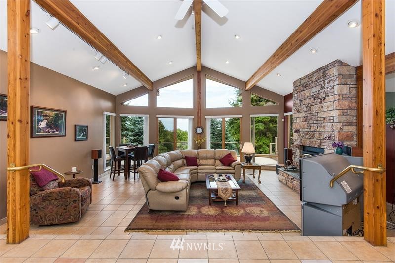 226 Guy Kelly Road Port Angeles, WA 98362 - Photo 10 of 40 a living room with fireplace furniture and a large window