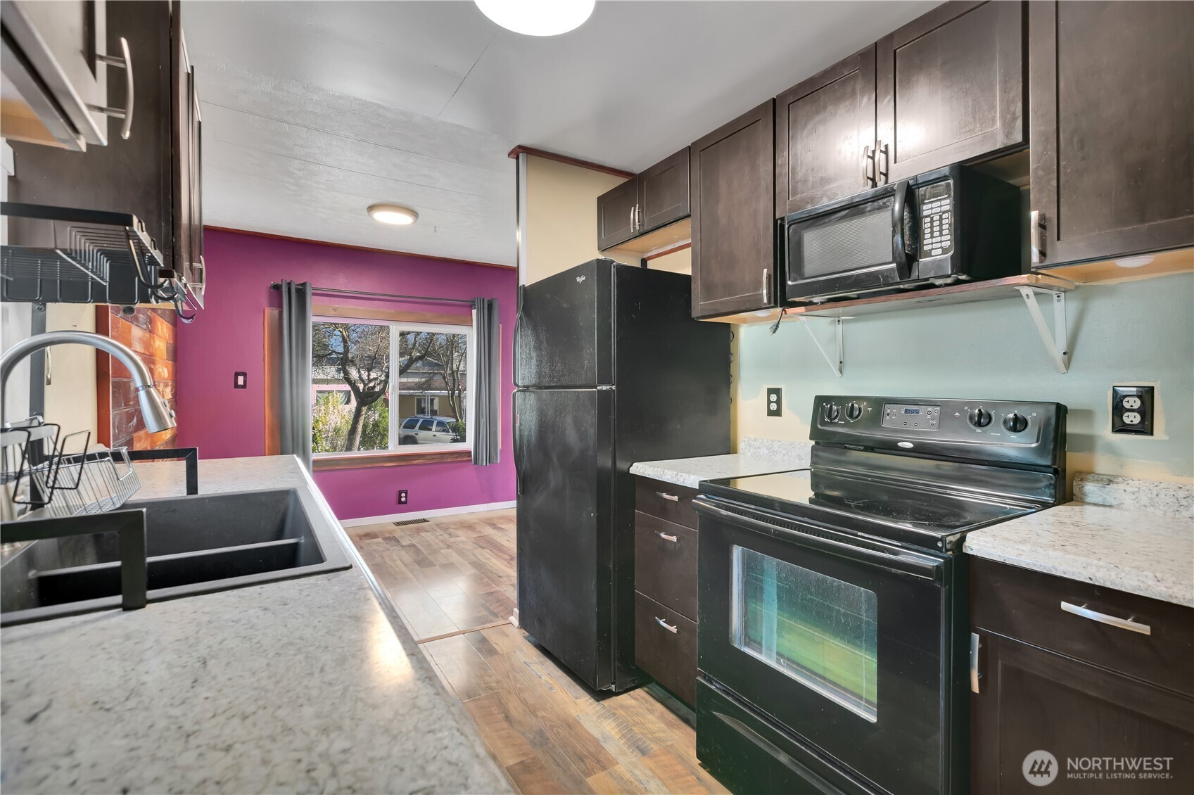 7311 Chambers Creek Road West, Unit 37 University Place, WA 98467 - Photo 12 of 23 a kitchen with stainless steel appliances granite countertop a stove a refrigerator and a sink