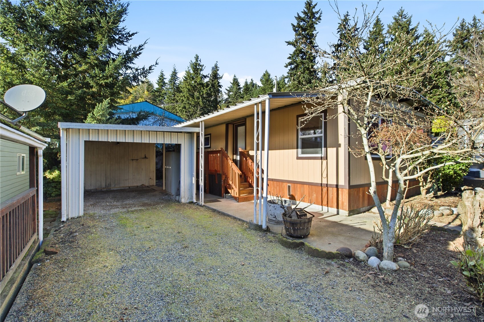 7311 Chambers Creek Road West, Unit 37 University Place, WA 98467 - Photo 2 of 23 a view of a house with a yard and garage