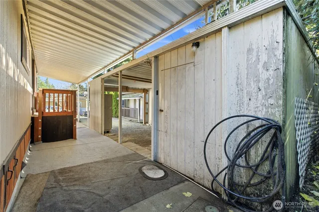 a view of a porch with a table and chairs