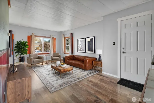 a living room with furniture rug and window