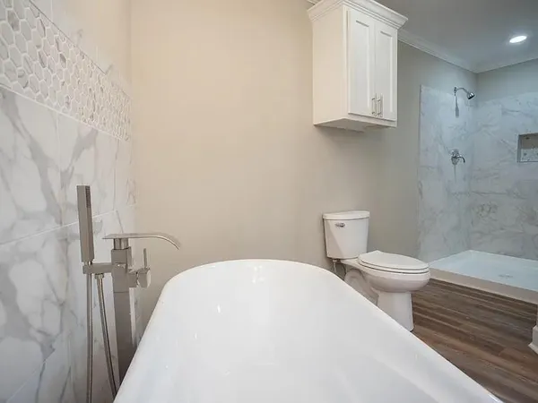 a bathroom with a toilet a sink and bathtub