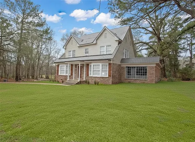 a front view of a house with a garden