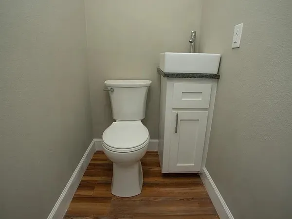 a white toilet sitting next to a bathroom sink
