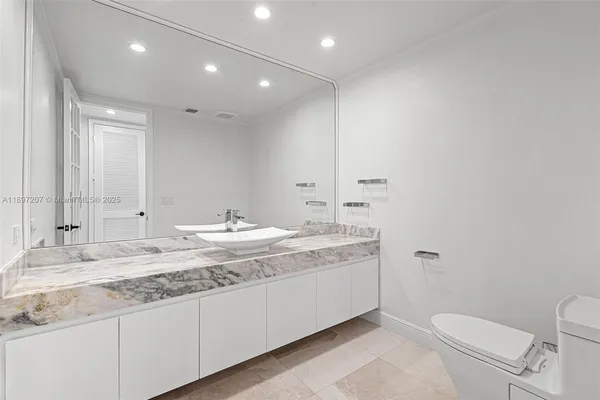a large white kitchen with a table and chairs in it