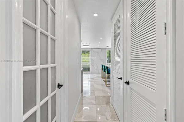 a kitchen with kitchen island white cabinets and refrigerator