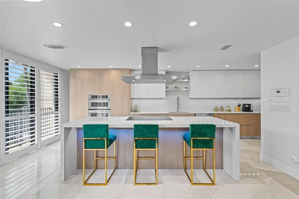 a large kitchen with a sink and cabinets