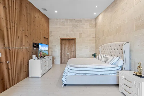a bathroom with a glass shower door a sink and a shower