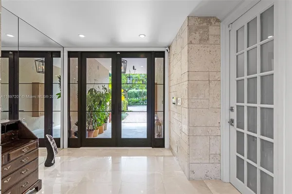 a living room with furniture large windows and a flat screen tv