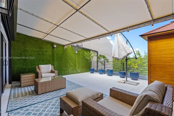 an aerial view of residential houses with outdoor space and parking